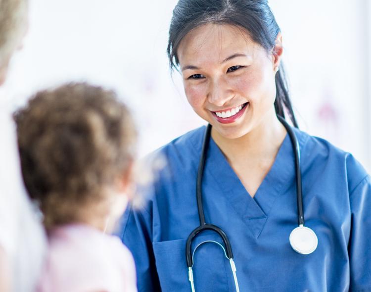 Female doctor smiling at a child