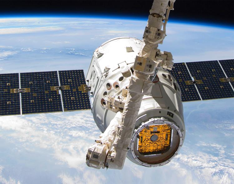 The SpaceX Dragon cargo craft is attached to the Candarm2 while in Space