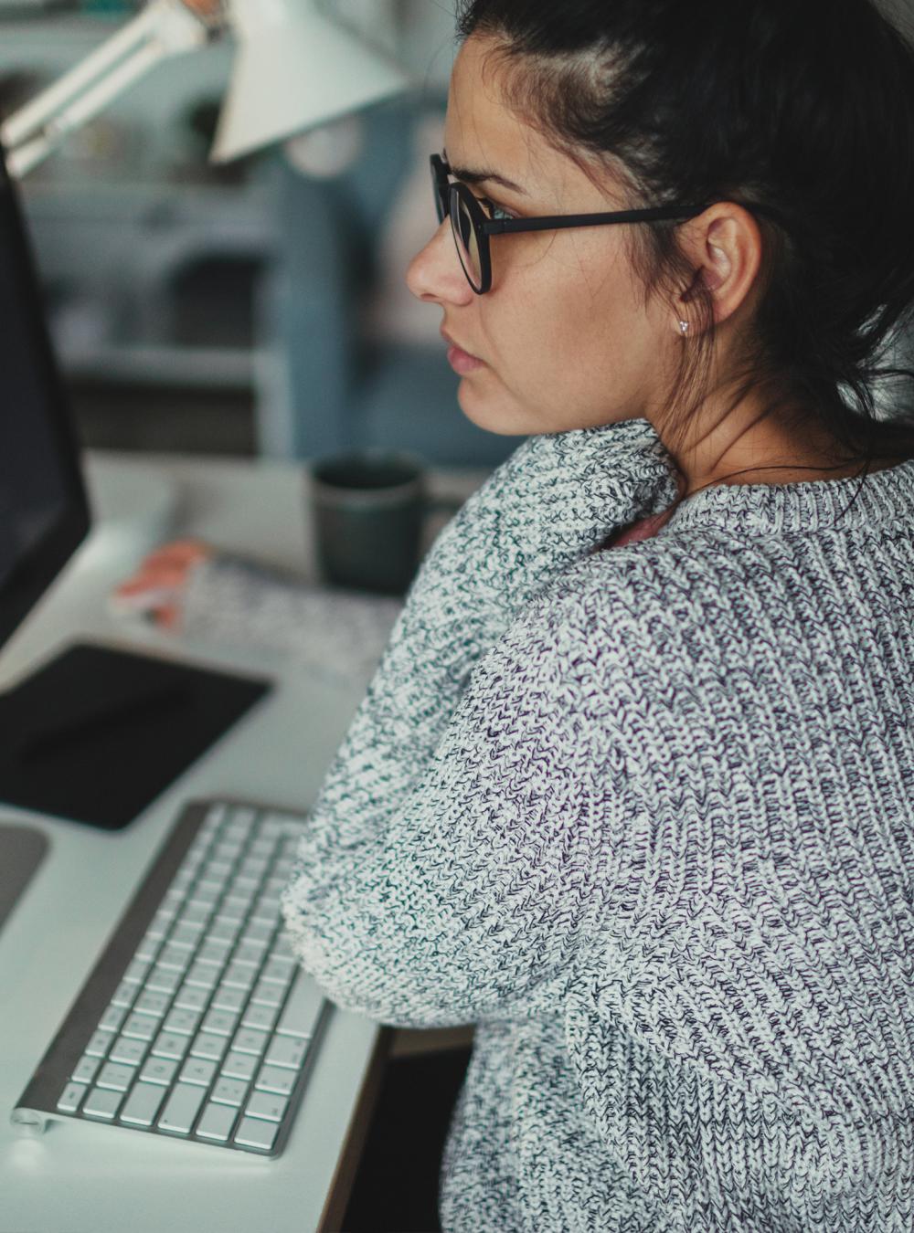 A woman sitting at a desk programming