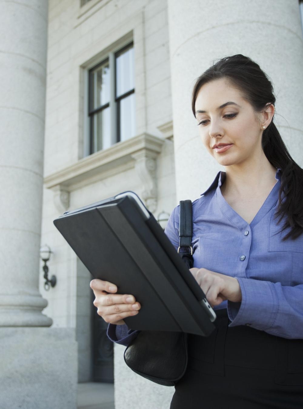Woman on a tablet outside of a government building