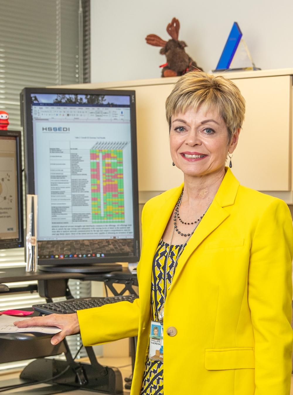 Terri Phillips standing in front of her computer
