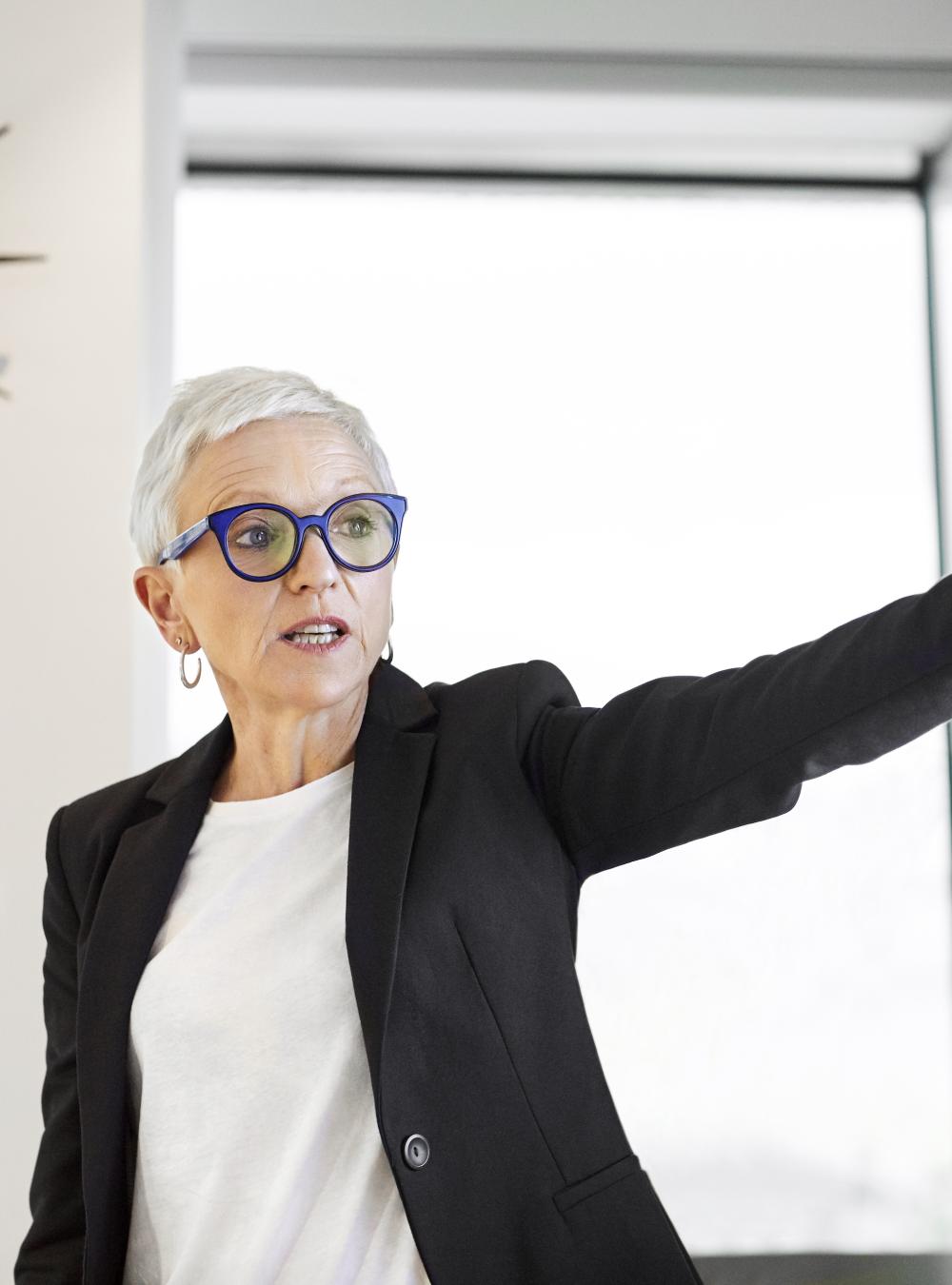 Woman presenting data in front of a conference room