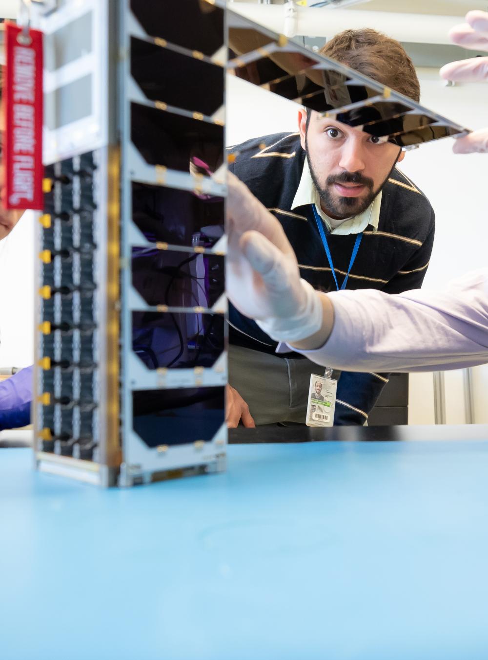 MITRE team working on a FUSE antenna, created in collaboration with the U.S. Naval Research Laboratory