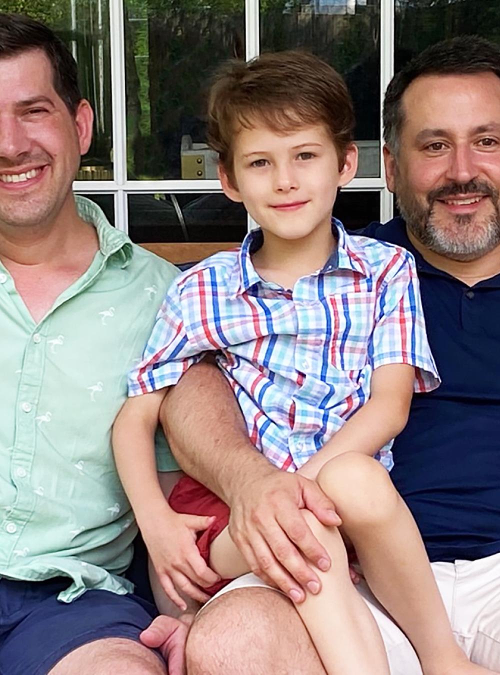 Charles Clancy (right, along with his husband Andrew and three children, Fiona, James, and Colin).