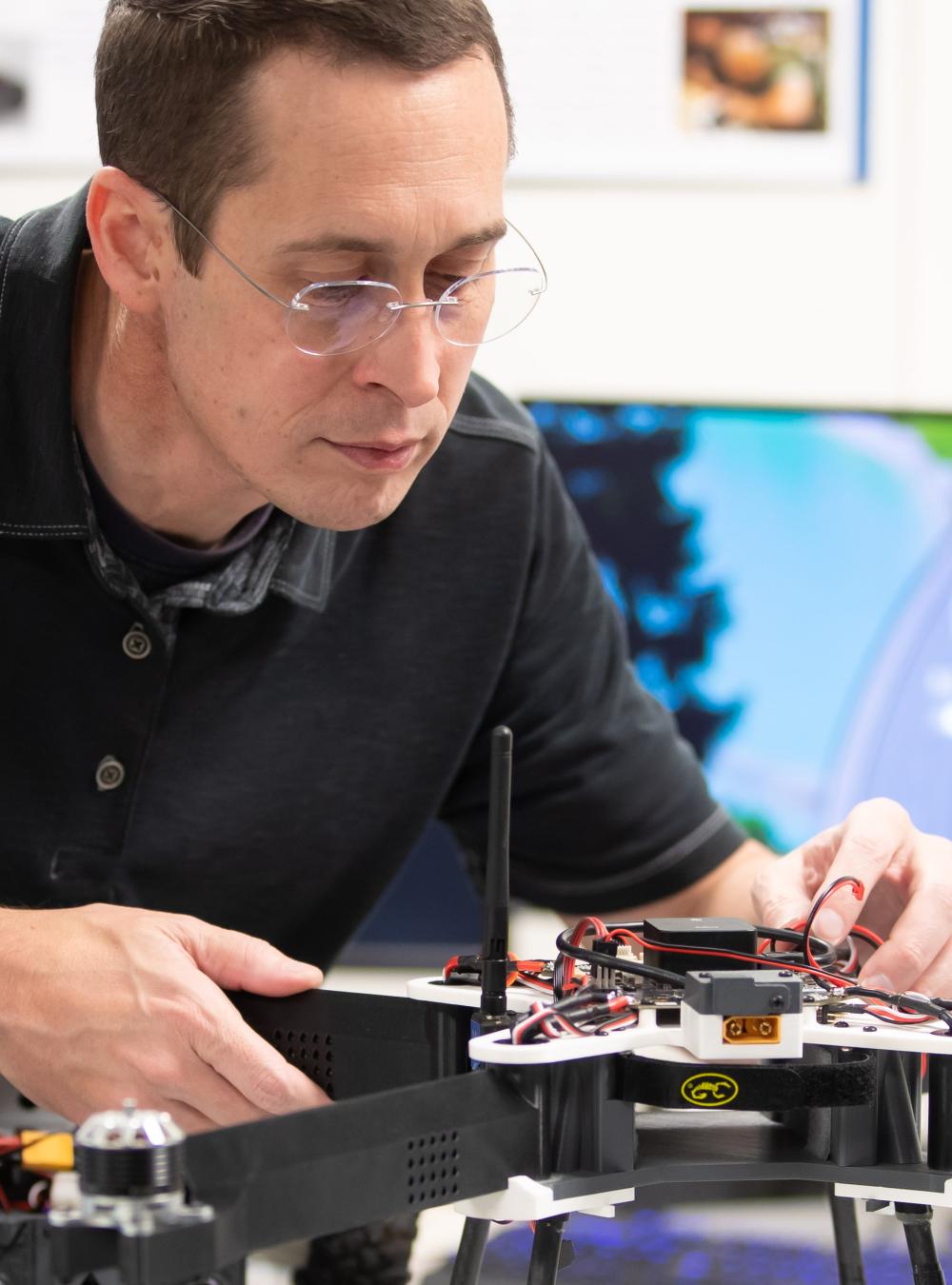 Employee working on a drone in the lab