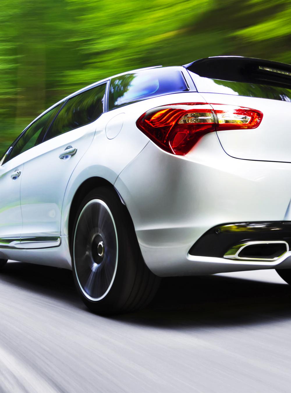 Low angle motion blur shot of generic car driving fast in a curve