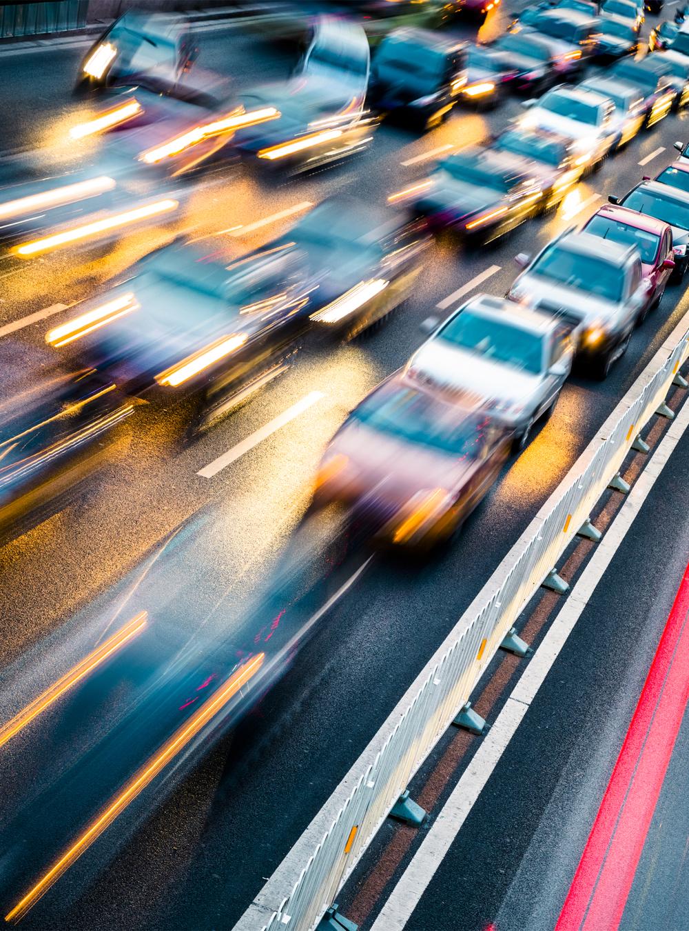 Cars in motion on a dark highway, showing the speed of traffic