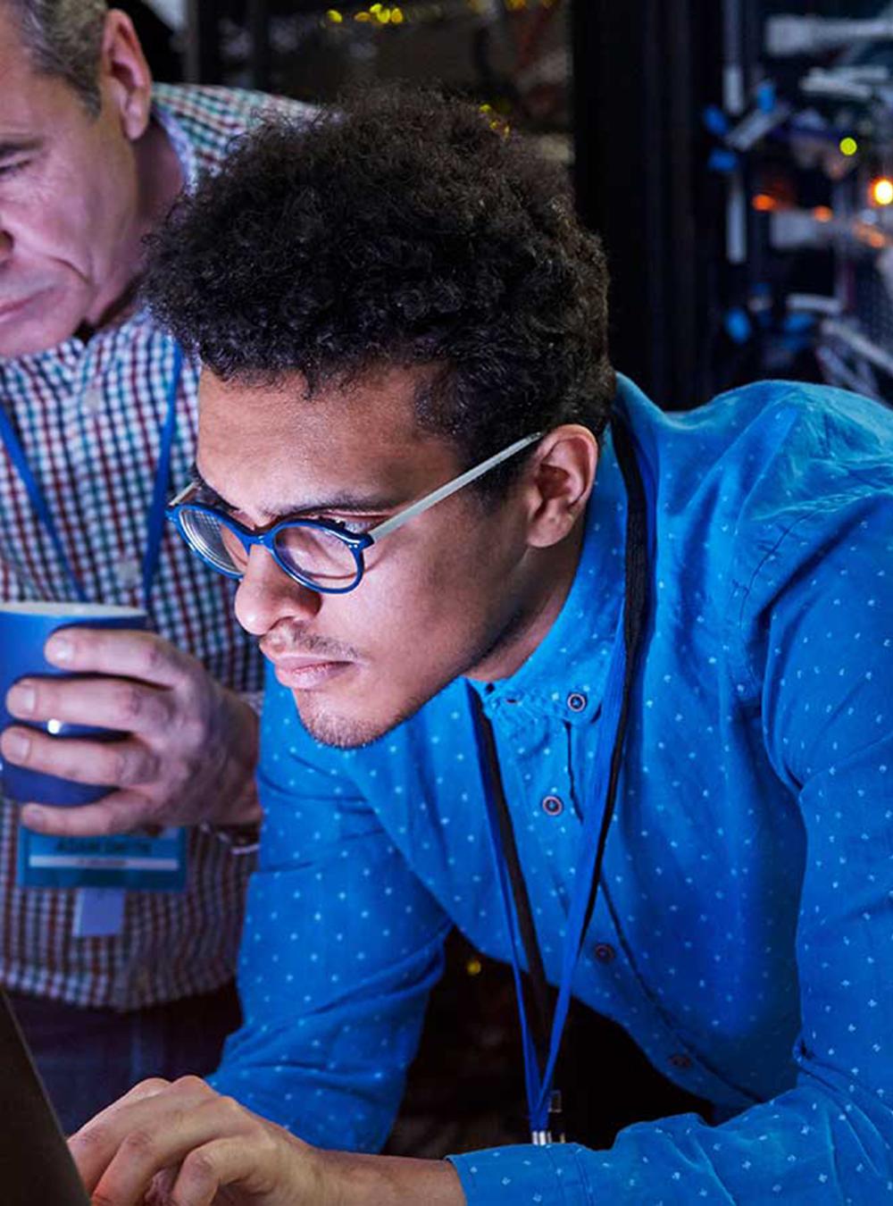 Two men looking at a laptop