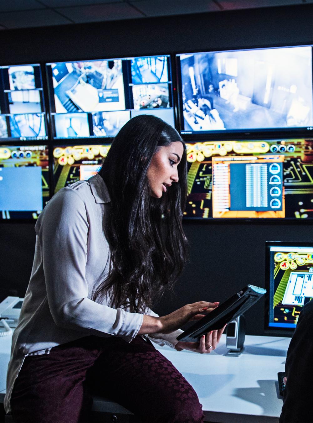 Security guards watching monitors in control room