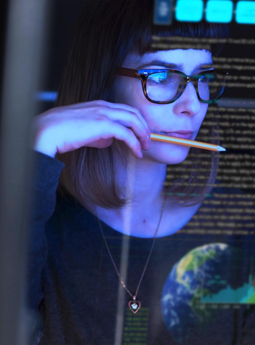 Woman looking at a transparent digital screen