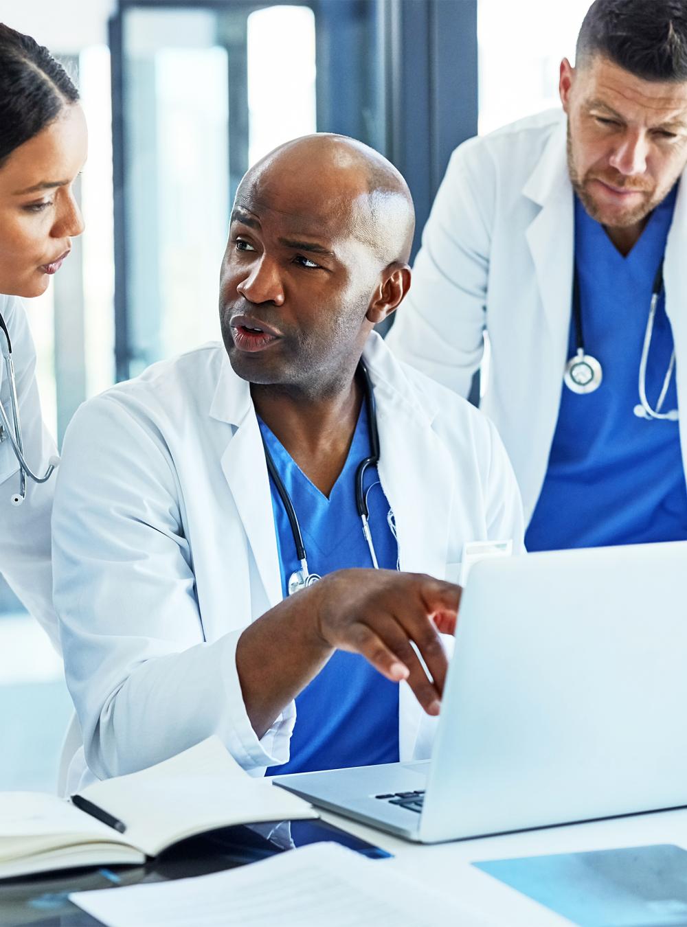 Doctors looking at laptop