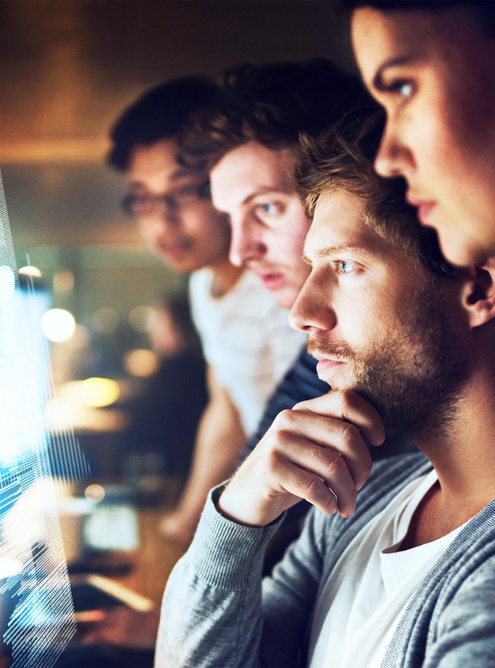 Cyber experts looking at computer screen