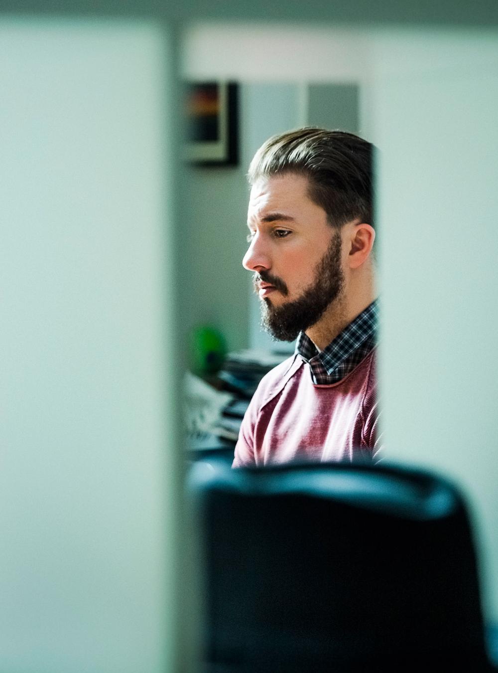 Man in his office looking at a computer screen