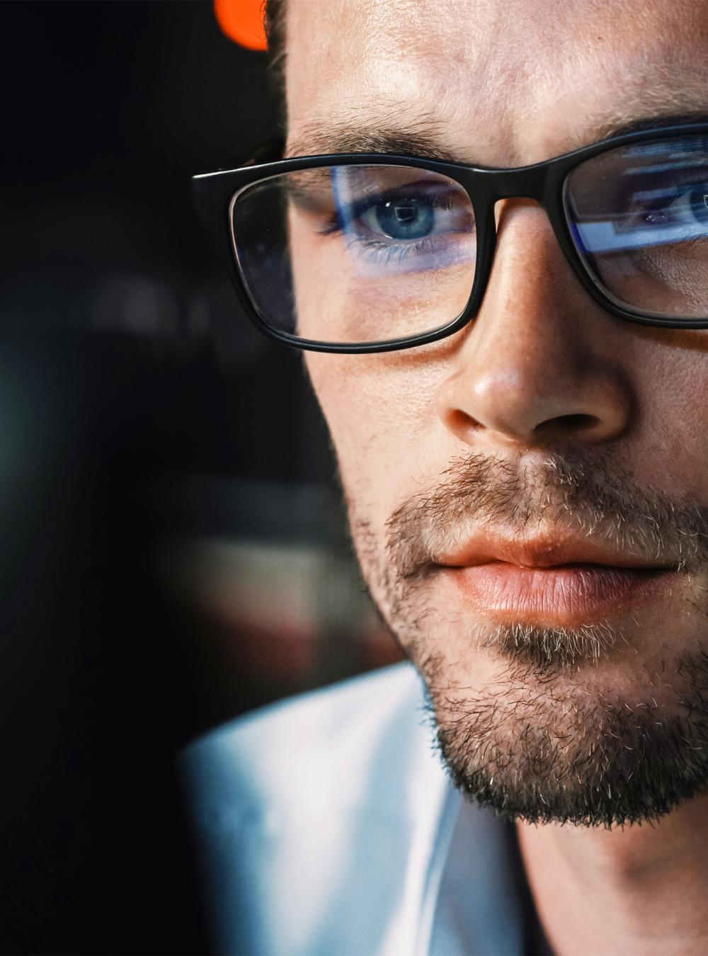 Close-up portrait of software engineer working on computer