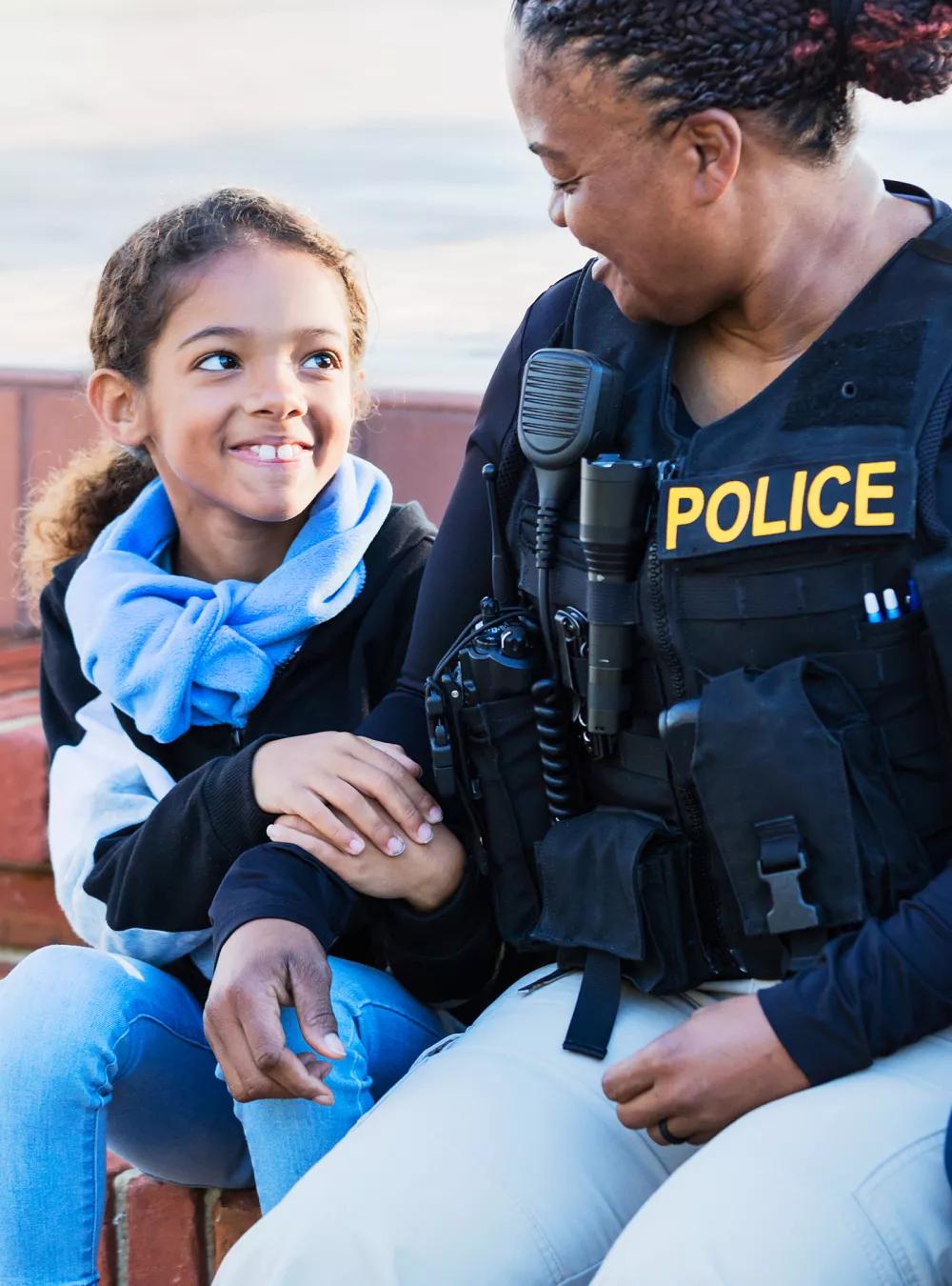 Policewoman in the community, sitting with two children