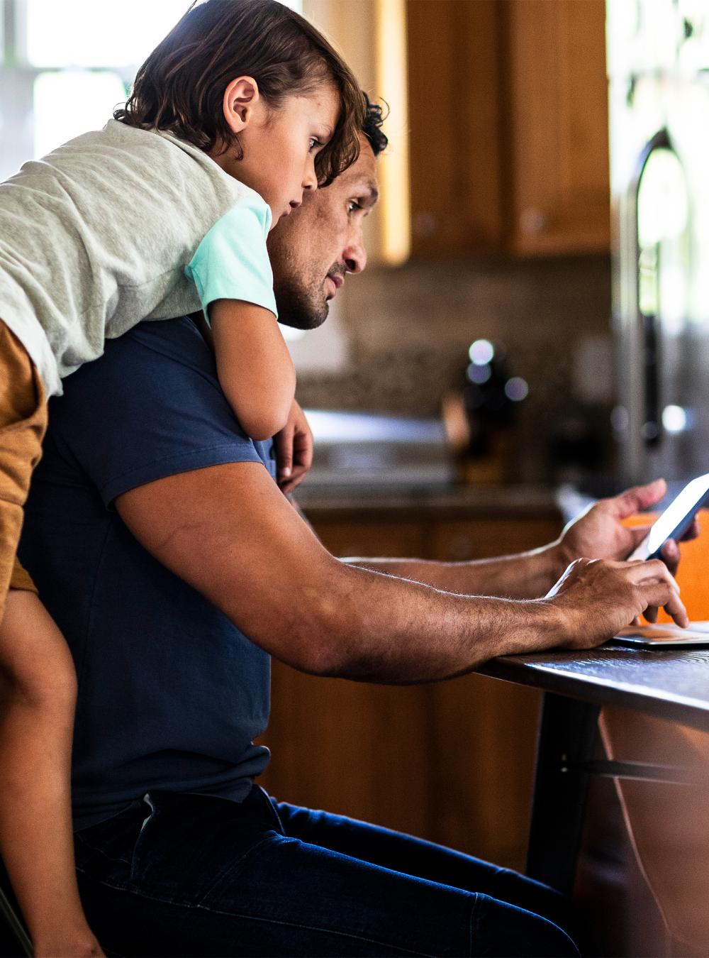 father and son looking at laptop computer