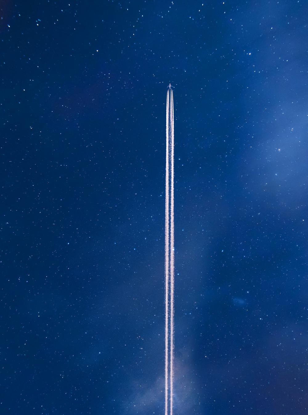 Airplane contrail against clear blue sky