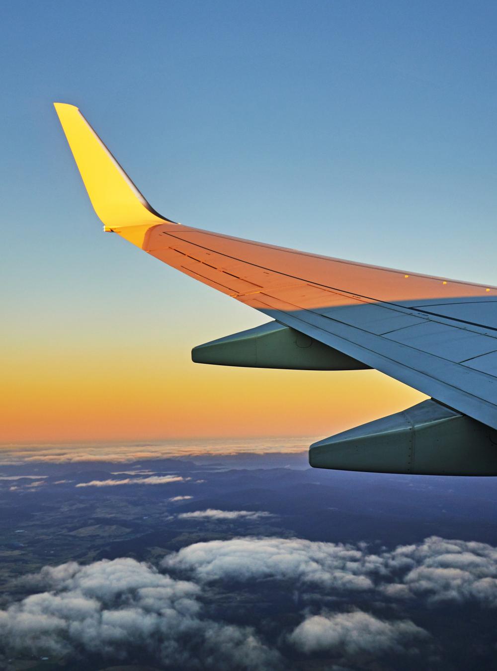 wing of a jet at sunset