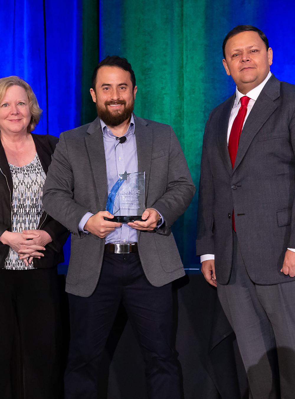 MITRE team receiving their ACT-IAC Emerging Technology Award at the 2023 ceremony.