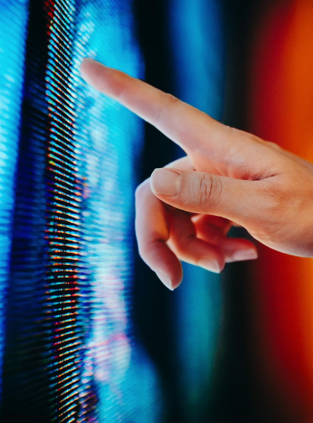 human pointing a finger at a display