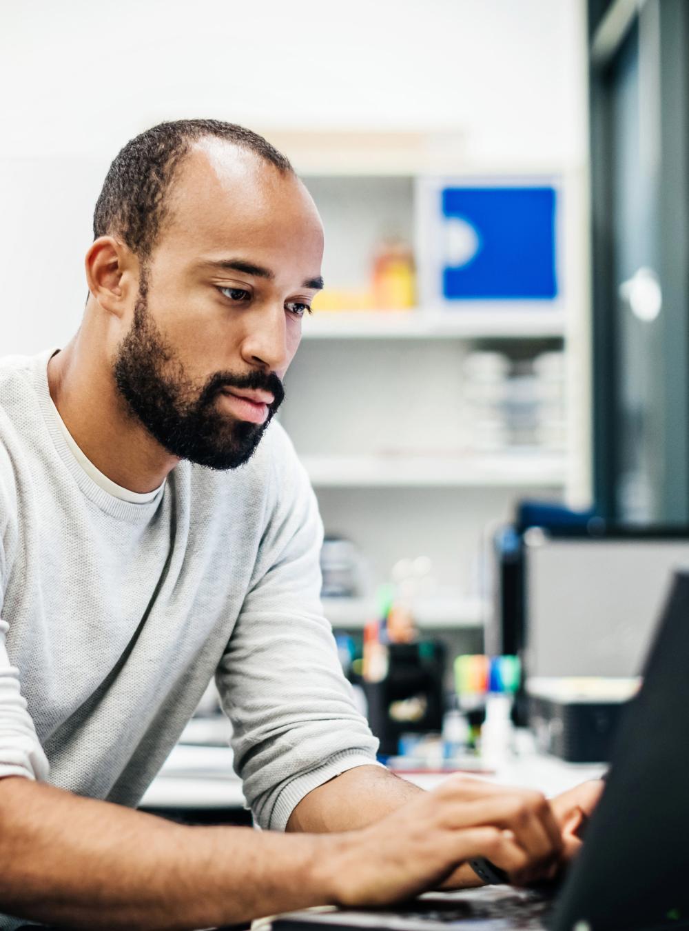 man working on laptop computer