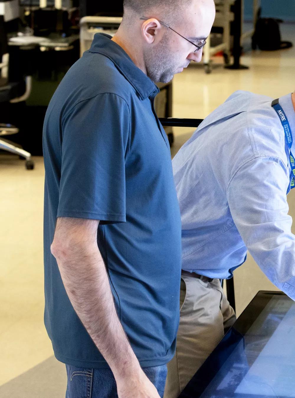 Employees using a touchscreen in the Edge Lab