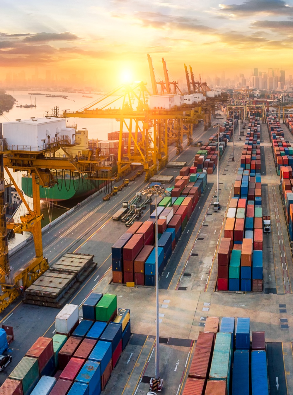 Logistics and transportation of Container Cargo ship and Cargo plane with working crane bridge in shipyard at sunrise, logistic import export and transport industry background