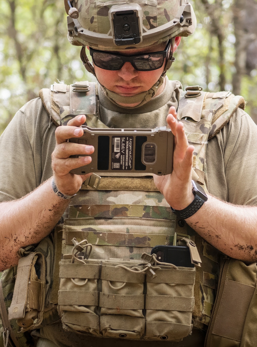 Person holding a tactical communication device