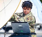 Air Force Airman 1st Class Rashin Ortiz aligns a satellite during Bamboo Eagle