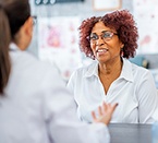 A woman speaking with a doctor