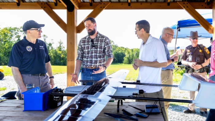 Stakeholders talking in front of a drone