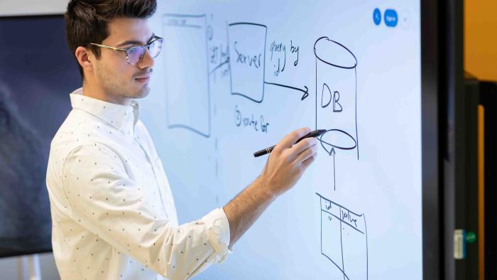 Matt Gramigna writing on a whiteboard