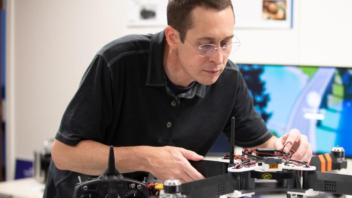 Employee working on a drone in the lab