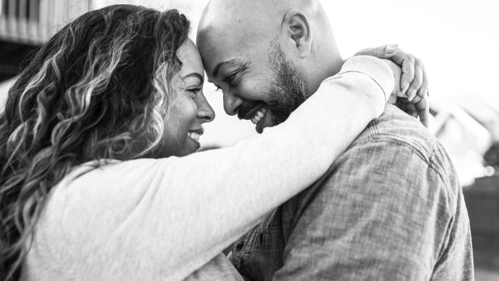 Husband and wife embracing outside