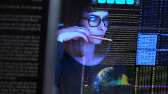 Woman looking at a transparent digital screen