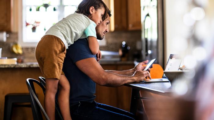 father and son looking at laptop computer