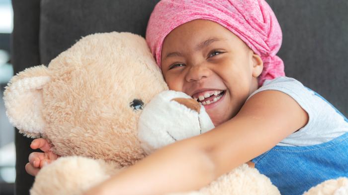 girl hugging a teddy bear