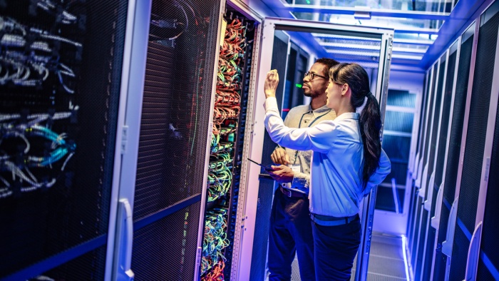 It engineers checking servers in server room
