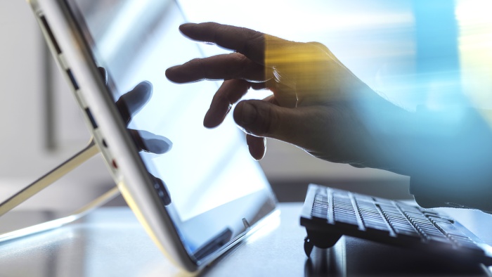 Hand touching a tablet PC screen