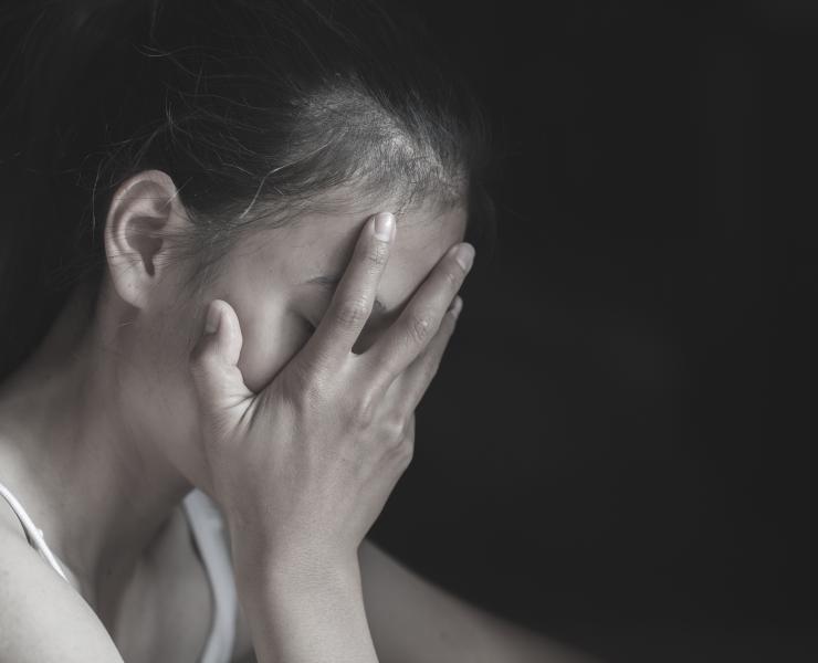 Young woman covering her face