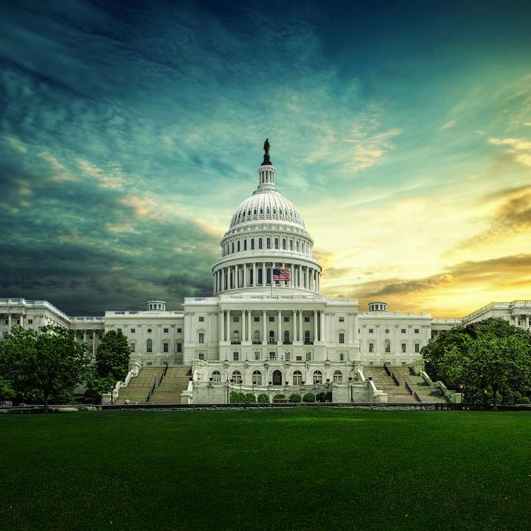 Capitol building framed by a dramatic sky