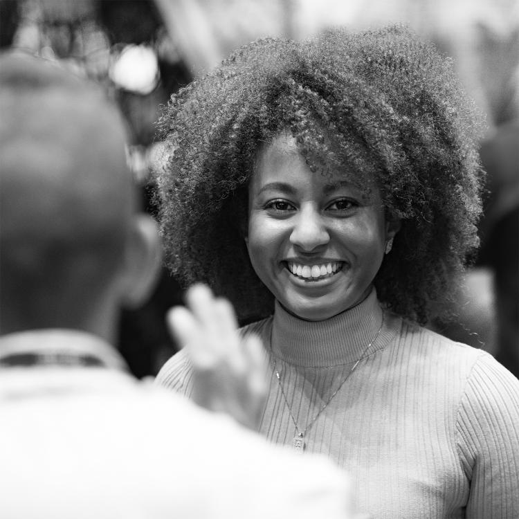 Woman smiling and having a conversation with a colleague