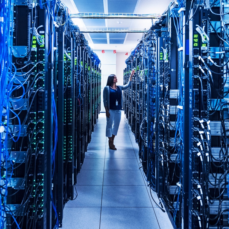Woman standing in aisle of server room